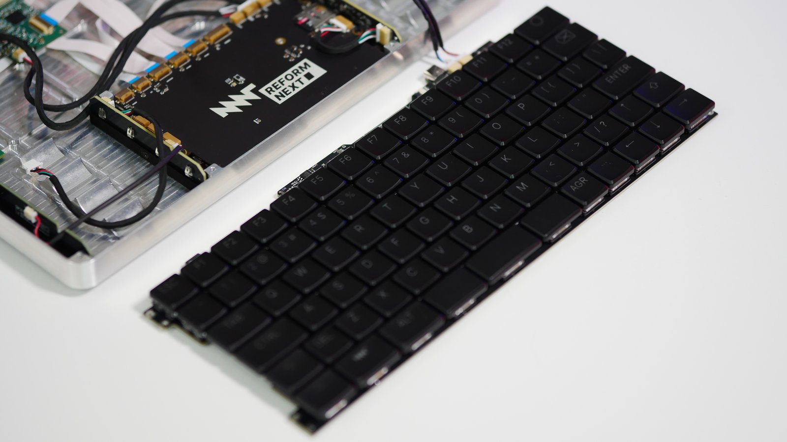 The MNT Reform keyboard, taken out of the Reform Next chassis and placed next to it on its own.