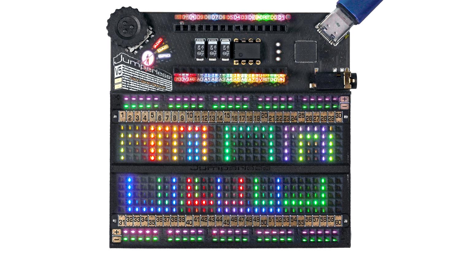 Jumperless V5 is a breadboard where any point can be connected to any other with software-defined jumpers. RGB LEDs under each hole turn the breadboar